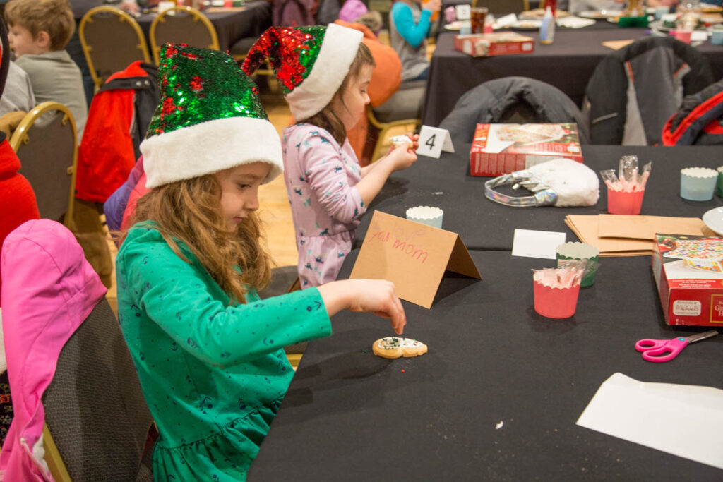Kids decorating cookies for Christmas at 49th State Brewing