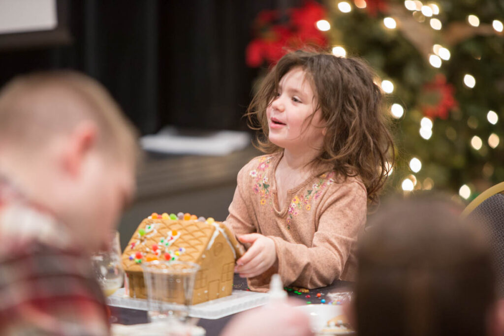 kid making gingerbread house for christmas at 49th State Brewing